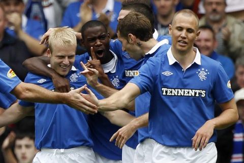 Rangers' Steven Naismith (L) celebrates with teammates after scoring against Kilmarnock during their Scottish Premier League soccer match at Ibrox Stadium in Glasgow, Scotland August 14, 2010. REUTERS/David Moir (BRITAIN - Tags: SPORT SOCCER)