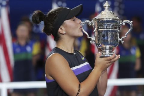 Bianca Andreescu, of Canada, kisses the championship trophy after defeating Serena Williams, of the United States, during the women's singles final of the U.S. Open tennis championships Saturday, Sept. 7, 2019, in New York. (AP Photo/Charles Krupa)