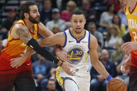 Utah Jazz guard Ricky Rubio, left, fouls Golden State Warriors guard Stephen Curry (30) as he drives up court in the first half during an NBA basketball game Wednesday Dec. 19, 2018, in Salt Lake City. (AP Photo/Rick Bowmer)