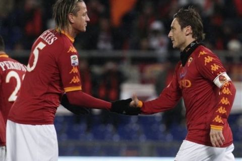 AS Roma forward Francesco Totti, right, celebrates with teammate Philippe Mexes, of France, after scoring during a Serie A soccer match between AS Roma and Cagliari at Rome's Olympic stadium, Saturday, Jan. 22, 2011. (AP Photo/Pier Paolo Cito)