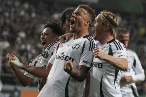 Legia Warsaw Steve Kapuadi, center, celebrates scoring his side's opening goal during the Europa League soccer match between Legia Warsaw and Real Betis in Warsaw, Poland, Thursday Oct. 3, 2024. (AP Photo/Czarek Sokolowski)