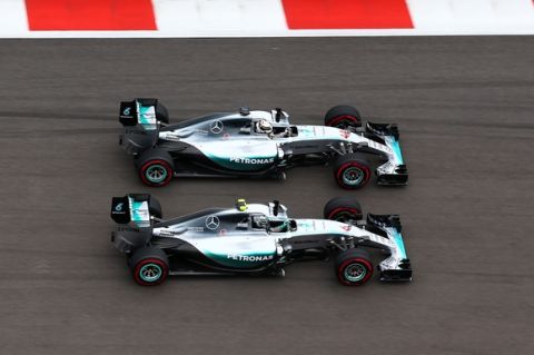 SOCHI, RUSSIA - OCTOBER 11:  Lewis Hamilton of Great Britain and Mercedes GP and Nico Rosberg of Germany and Mercedes GP race into the first corner during the Formula One Grand Prix of Russia at Sochi Autodrom on October 11, 2015 in Sochi, Russia.  (Photo by Clive Mason/Getty Images)