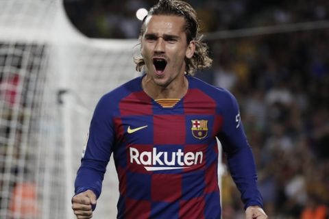 Barcelona's Antoine Griezmann celebrates after scoring the opening goal during the Spanish La Liga soccer match between FC Barcelona and Villarreal CF at the Camp Nou stadium in Barcelona, Spain, Tuesday, Sep. 24, 2019. (AP Photo/Joan Monfort)