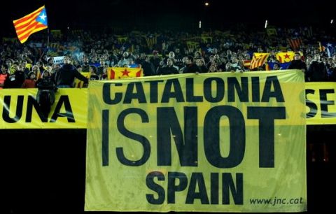 BARCELONA, SPAIN - DECEMBER 22:  Catalans hold a large banner reading 'Catalonia is not Spain' as the Catalan anthem played prior to the start of the international friendly match between Catalunya and Argentina at the Camp Nou stadium on December 22, 2009 in Barcelona, Spain.  (Photo by Jasper Juinen/Getty Images)