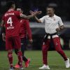 Toluca head coach Ignacio Ambriz, right, and Valber Huerta (4) celebrate at the end of a Mexican soccer semifinal league match against America at Azteca Stadium in Mexico City, Saturday, Oct. 22, 2022. (AP Photo/Eduardo Verdugo)