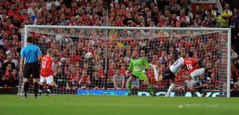 Manchester United's English forward Danny Welbeck (R) scores during the English Premier League football match between Manchester United and Tottenham Hotspur at Old Trafford in Manchester, north west England, on August 22, 2011. AFP PHOTO/ANDREW YATES - RESTRICTED TO EDITORIAL USE. No use with unauthorized audio, video, data, fixture lists, club/league logos or live services. Online in-match use limited to 45 images, no video emulation. No use in betting, games or single club/league/player publications (Photo credit should read ANDREW YATES/AFP/Getty Images)