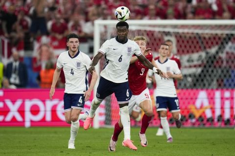 England's Marc Guehi (6) heads the ball ahead of Denmark's Rasmus Hojlund (9) during a Group C match between Denmark and England at the Euro 2024 soccer tournament in Frankfurt, Germany, Thursday, June 20, 2024. (AP Photo/Themba Hadebe)