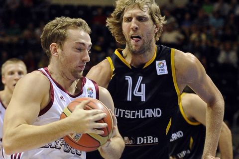 Germany's Dirk Nowitzki (R) vies with Latvia's Rihards Kuksiks during the EuroBasket 2011 first round Group B qualifying match between Germany and Latvia in Siauliai on September 5, 2011. AFP PHOTO / JANEK SKARZYNSKI (Photo credit should read JANEK SKARZYNSKI/AFP/Getty Images)