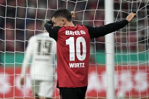 Leverkusen's Florian Wirtz holds the goal net during the German Soccer Cup match between Bayer Leverkusen and SV Elversberg at the BayArena in Leverkusen, Germany, Tuesday, Oct. 29, 2024. (AP Photo/Martin Meissner)