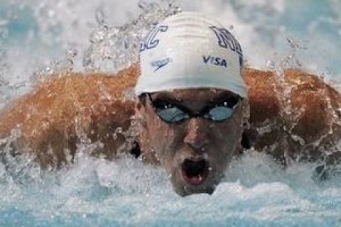 Michael Phelps competes on his way to a world-record time of 50.22 seconds to win the men's 100-meter butterfly at the U.S. national swimming championships in Indianapolis, Thursday, July 9, 2009. (AP Photo/Darron Cummings)