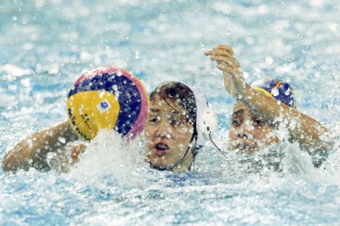 Greece's Alexandra Asimaki fights for control of the ball against Spain's Lorena Miranda Dorado during their preliminary round women's water polo match at the 14th FINA World Championships in Shanghai July 17, 2011.  REUTERS/Issei Kato (CHINA  - Tags: SPORT WATER POLO)