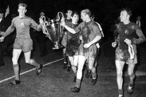 1968 European Cup Final Manchester United v Benfica
 Goalkeeper Alex Stepney (left) and Bobby Charlton, with Tony Dunne lending a hand in between them, carry the European Cup as Manchester United players make the lap of honour at Wembley Stadium, after beating Benfica 4-1 in the final. Extreme right is Pat Crerand.
 29th May 1968
 Mandatory Credit: Action Images / Topham