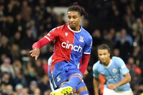 Crystal Palace's Michael Olise shoots a penalty kick to score during the English Premier League soccer match between Manchester City and Crystal Palace at the Etihad Stadium in Manchester, England, Saturday, Dec.16, 2023. (AP Photo/Dave Thompson)