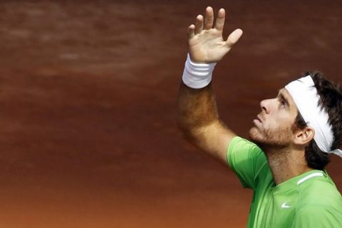 Juan Martin del Potro of Argentina looks up to the sky as he celebrates his victory over Marin Cilic of Croatia during their Madrid Open tennis match May 4, 2011.  REUTERS/Susana Vera (SPAIN - Tags: SPORT TENNIS)