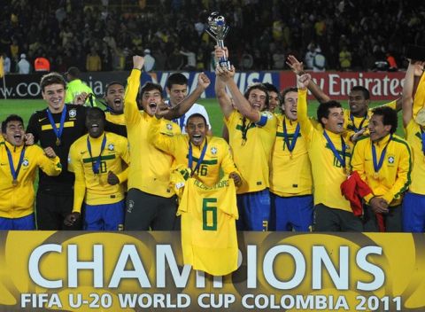 Brazilian players celebrate with the trophy and injured player Alex Sandro´s kit after beating Portugal in the FIFA 2011 Under-20 World Cup final match in Bogota on August 20, 2011. Brazil won 3-2 in overtime.  AFP PHOTO / EITAN ABRAMOVICH (Photo credit should read EITAN ABRAMOVICH/AFP/Getty Images)