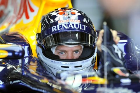 Red Bull-Renault driver Sebastian Vettel of Germany wears his gloves in the pit during the third practice session of the Formula One Japanese Grand Prix at Suzuka on October 8, 2011.  AFP PHOTO/JUNG YEON-JE (Photo credit should read JUNG YEON-JE/AFP/Getty Images)