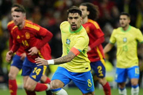 Brazil's Lucas Paqueta reacts after scoring his side's third goal with a penalty kick during a friendly soccer match between Spain and Brazil at the Santiago Bernabeu stadium in Madrid, Spain, Tuesday, March 26, 2024. (AP Photo/Jose Breton)