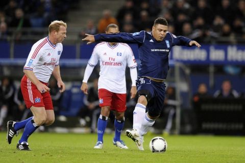 Brazilian football star Ronaldo (R) and Hamburg's Joerg Albertz vie for the ball during the "Match Against Poverty" friendly charity football in support of Horn of Africa famine relief led by the United Nations Development Programme (UNDP) between an all-star side of Hamburger SV and a selection of other International players including UNDP Goodwill Ambassadors Ronaldo and Zidane in the northern German city of Hamburg on December 13, 2011.  AFP PHOTO / OLIVER HARDT (Photo credit should read OLIVER HARDT/AFP/Getty Images)