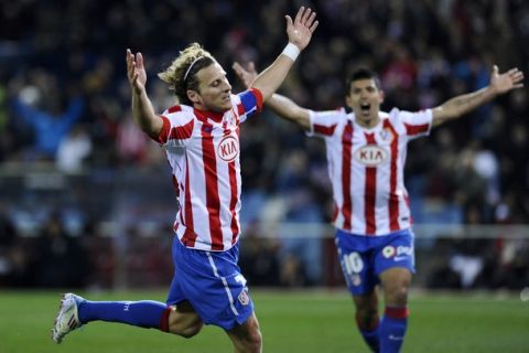 Atletico Madrid's Uruguayan forward Diego Forlan (L) celebrates after scoring during their Spanish league football match Atletico de Madrid vs Villarreal on March 5, 2011 at the Vicente Calderon stadium in Madrid. AFP PHOTO/ PIERRE-PHILIPPE MARCOU (Photo credit should read PIERRE-PHILIPPE MARCOU/AFP/Getty Images)