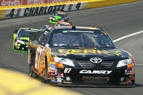 Kimi Raikkonen of Finland (87) drives through turn four during the NASCAR Nationwide Series Top Gear 300 in Concord, North Carolina May 28, 2011. REUTERS/Chris Keane (UNITED STATES - Tags: SPORT MOTOR RACING)