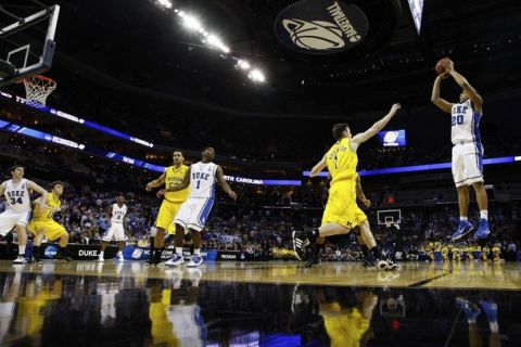 Duke Blue Devils guard Andre Dawkins (20) shoots the ball over Michigan Wolverines guard Stu Douglass (1) during their third round NCAA men's basketball game in Charlotte, North Carolina March 20, 2011. REUTERS/Chris Keane (UNITED STATES - Tags: SPORT BASKETBALL)