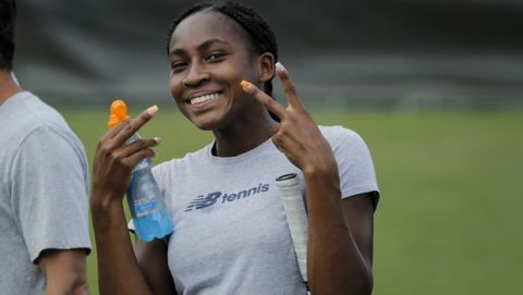 United States' Cori Gauff gestures to photographers during a practice session ahead of the Wimbledon Tennis Championships in London Sunday, June 30, 2019. (AP Photo/Ben Curtis)