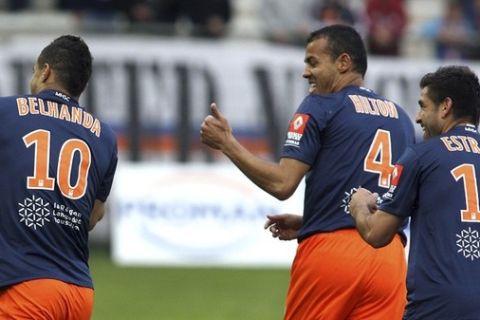 Montpellier's Younes Belhanda (L) reacts with Hilton and Marco Estrada after he scored against Sochaux during their French ligue 1 soccer match at the Mosson stadium in Montpellier April 7, 2012. REUTERS/Pascal Parrot (FRANCE - Tags: SPORT SOCCER)