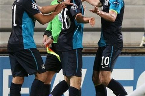 Arsenal's midfielder Aaron Ramsey from Britain, center,  Brazilian defender Andre Santos, left,  Dutch forward Robin van Persie , react after Ramsey scored  against Marseille, during  their Champions League Group F soccer match, at the Velodrome Stadium, in Marseille, southern France, Wednesday, Oct. 19, 2011. (AP Photo/Claude Paris)