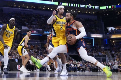 New York Knicks guard Jalen Brunson (11) drives to the basket past Indiana Pacers guard Andrew Nembhard (2) during the first half of Game 4 in an NBA basketball second-round playoff series, Sunday, May 12, 2024, in Indianapolis. (AP Photo/Michael Conroy)