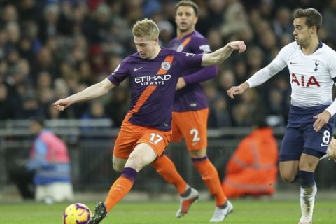 Manchester City's Kevin De Bruyne, left, attempts a shot at goal during the English Premier League soccer match between Tottenham Hotspur and Manchester City at Wembley stadium in London, England, Monday, Oct. 29, 2018. (AP Photo/Tim Ireland)