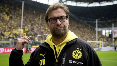 Dortmund head coach Juergen Klopp removes his earpiece on a TV set next to the pitch prior to the German first division Bundesliga football match between Borussia Dortmund and 1899 Hoffenheim in Dortmund on May 18, 2013.   AFP PHOTO / ODD ANDERSEN

RESTRICTIONS / EMBARGO - DFL RULES TO LIMIT THE ONLINE USAGE DURING MATCH TIME TO 15 PICTURES PER MATCH. IMAGE SEQUENCES TO SIMULATE VIDEO IS NOT ALLOWED AT ANY TIME. FOR FURTHER QUERIES PLEASE CONTACT DFL DIRECTLY AT + 49 69 650050.ODD ANDERSEN/AFP/Getty Images