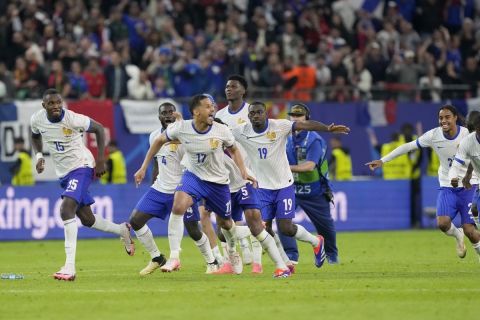 France players run celebrating after Theo Hernandez of France scored the winning igoaln a penalty shootout after the match end goalless during a quarter final match between Portugal and France at the Euro 2024 soccer tournament in Hamburg, Germany, Friday, July 5, 2024. (AP Photo/Martin Meissner)