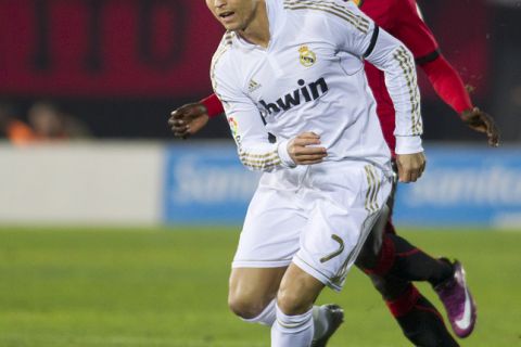 Real Madrid's Portuguese forward Cristiano Ronaldo (L) vies with Mallorca's French midfielder Michael Pereira during the Spanish league football match between Mallorca and Real Madrid at the Iberostar stadium in Palma de Mallorca on January 14, 2012.  AFP PHOTO / JAIME REINA (Photo credit should read JAIME REINA/AFP/Getty Images)