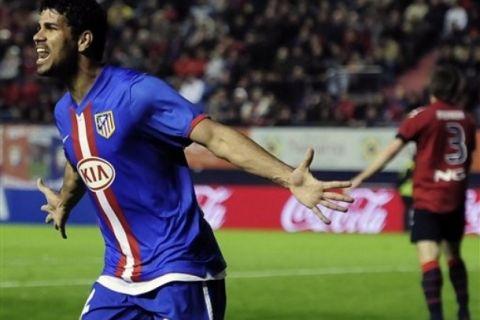 Atletico de Madrid's  Diego Costa from Brazil, left,  celebrates after he scored against Osasuna during their Spanish La Liga soccer match at Reyno de Navarra stadium in Pamplona, northern  Spain Sunday  April 3, 2011. (AP Photo/Alvaro Barrientos)