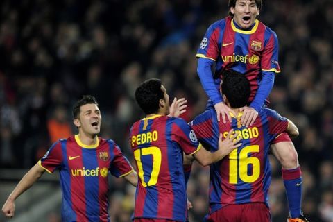 Barcelona's Argentinian forward Lionel Messi (R-up) is congratulated by his teammates during their Champions League round of 16, second leg football match FC Barcelona vs Arsenal on March 8, 2011 at Camp Nou stadium in Barcelona. AFP PHOTO/ JOSEP LAGO (Photo credit should read JOSEP LAGO/AFP/Getty Images)