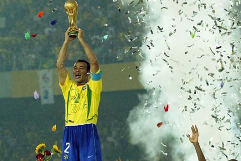 Brazilian team captain Cafu holds aloft the World Cup at the end of the 2002 World Cup final soccer match between Brazil and Germany Sunday, June 30, 2002 in Yokohama, Japan. Brazil won the match 2-0. (AP Photo/Thomas Kienzle)