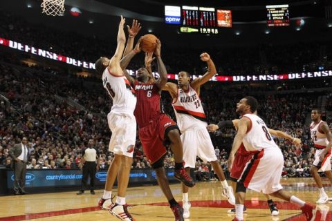 PORTLAND, OR - JANUARY 9: LaBron James #6 of the Miami Heat   is drives the lane against Nicolas Bantum #88 of the Portland Trail Blazers during a game on January 9, 2011 at the Rose Garden Arena in Portland, Oregon. NOTE TO USER: User expressly acknowledges and agrees that, by downloading and or using this photograph, User is consenting to the terms and conditions of the Getty Images License Agreement.(Photo by Tom Hauck/Getty Images)