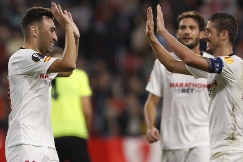 Sevilla's Munir, left, celebrates after scoring his side's third goal during the Europa League group A soccer match between Sevilla and Dudelange at the Estadio Ramon Sanchez-Pizjuan stadium in Seville, Spain, Thursday, Oct. 24, 2019. (AP Photo/Miguel Morenatti)