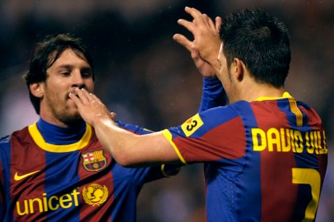 Barcelona's forward David Villa (R) celebrates with teammate Argentinian forward Lionel Messi (L) after scoring against Deportivo during the Spanish league football match RC Deportivo de la Coruna vs Barcelona FC on January 8, 2011 at Municipal de Riazor stadium in La Coruna.    AFP PHOTO/ MIGUEL RIOPA (Photo credit should read MIGUEL RIOPA/AFP/Getty Images)