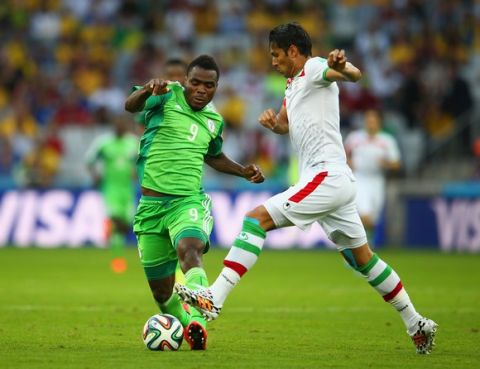 CURITIBA, BRAZIL - JUNE 16: Emmanuel Emenike of Nigeria controls the ball against Amirhossein Sadeghi of Iran during the 2014 FIFA World Cup Brazil Group F match between Iran and Nigeria at Arena da Baixada on June 16, 2014 in Curitiba, Brazil.  (Photo by Julian Finney/Getty Images)