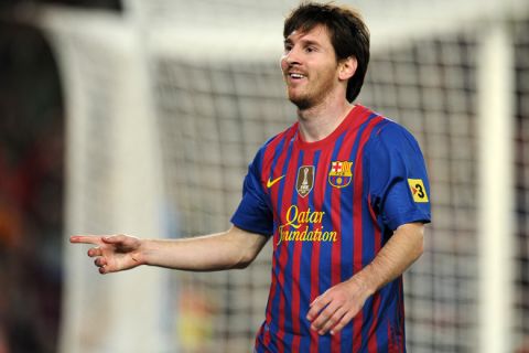 Barcelona's Argentinian forward Lionel Messi celebrates after scoring a goal during the Spanish league football match FC Barcelona vs RCD Espanyol on May 5, 2012 at the Camp Nou stadium in Barcelona. AFP PHOTO/LLUIS GENELLUIS GENE/AFP/GettyImages