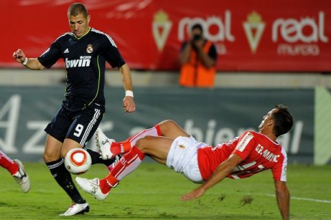 Real Madrid's French forward Karim Benzema (L) vies with Real Murcias Ivan  Amaya during their Spanish Copa del Rey (King's cup) football match on October 26, 2010 at Condomina  stadium in Murcia.     AFP PHOTO/ JOSE JORDAN (Photo credit should read JOSE JORDAN/AFP/Getty Images)