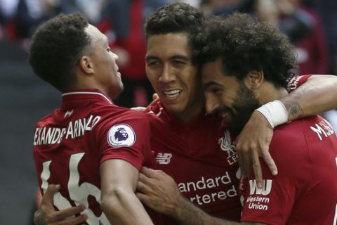 Liverpool's Roberto Firmino, center celebrates with his team mates after he scored his side second goal during the English Premier League soccer match between Tottenham Hotspur and Liverpool at Wembley Stadium in London, Saturday Sept. 15, 2018. (AP Photo/Tim Ireland)