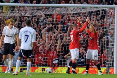 Manchester United's English forward Wayne Rooney (2R) celebrates scoring during the English Premier League football match between Manchester United and Tottenham Hotspur at Old Trafford in Manchester, north west England, on August 22, 2011. AFP PHOTO/ANDREW YATES - RESTRICTED TO EDITORIAL USE. No use with unauthorized audio, video, data, fixture lists, club/league logos or live services. Online in-match use limited to 45 images, no video emulation. No use in betting, games or single club/league/player publications (Photo credit should read ANDREW YATES/AFP/Getty Images)