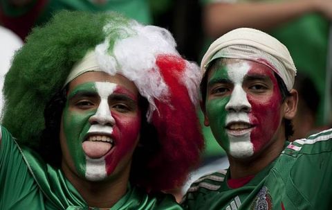 Mexican fans cheer during the U-17 World Cup final football match against Uruguay at the Azteca stadium in Mexico City on July 10, 201.   AFP PHOTO/ Yuri CORTEZ (Photo credit should read YURI CORTEZ/AFP/Getty Images)