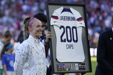 United States' Becky Sauerbrunn is honored on her 200th match before the start of an international friendly soccer match against Ireland Tuesday, April 11, 2023, in St. Louis. (AP Photo/Jeff Roberson)