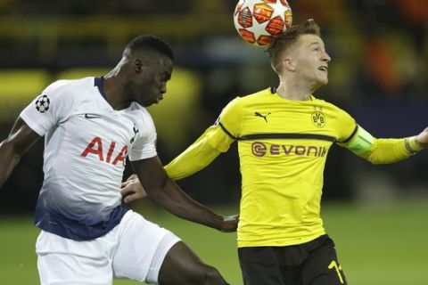 Tottenham defender Davinson Sanchez, left, and Dortmund midfielder Marco Reus battle for the ball during the Champions League round of 16, 2nd leg, soccer match between Borussia Dortmund and Tottenham Hotspur at the BVB stadium in Dortmund, Germany, Tuesday, March 5, 2019. (AP Photo/Michael Probst)