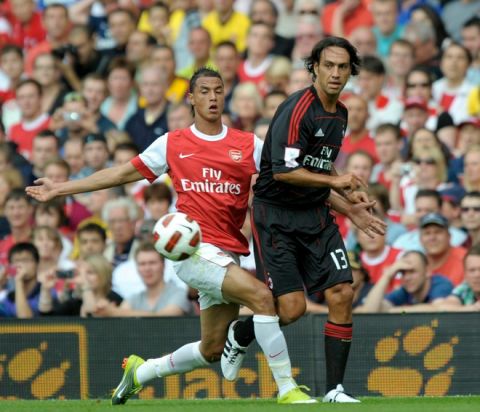 Arsenal's Marouane Chamakh (L) competes with AC Milan's Alessandro Nesta during their Emirates Cup football match at Emirates Stadium in London, England on July 31, 2010.  AFP PHOTO/Olly Greenwood

FOR EDITORIAL USE ONLY Additional license required for any commercial/ promotional use or use on TV or internet (except identical online version of newspaper) of Premier League/Football photos. Tel DataCo  
+44 207 2981656. Do not alter/modify photo. (Photo credit should read OLLY GREENWOOD/AFP/Getty Images)(Photo Credit should Read /AFP/Getty Images)