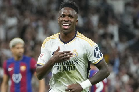 FILE - Real Madrid's Vinicius Junior celebrates after scoring his side's opening goal during the Spanish La Liga soccer match between Real Madrid and Barcelona at the Santiago Bernabeu stadium in Madrid, Spain, Sunday, April 21, 2024. (AP Photo/Manu Fernandez) , File)