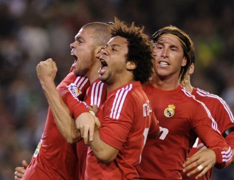 Real Madrid's Portuguese defender Pepe (L), Real Madrid's Brazilian defender Marcelo (C) and Real Madrid's defender Sergio Ramos (R) celebrate their scoring against Betis during a Spanish League football match Real Madrid vs Betis on March 10, 2012 at Benito Villamarin stadium in Sevilla. AFP PHOTO/ CRISTINA QUICLER (Photo credit should read CRISTINA QUICLER/AFP/Getty Images)